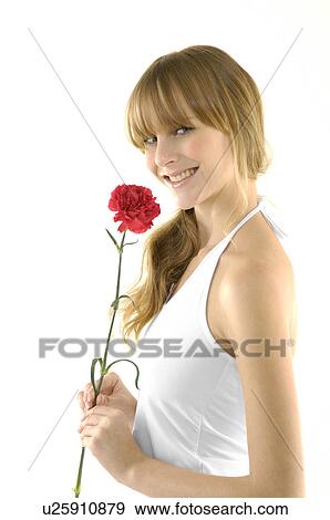 Stock Photo - Portrait of a young woman holding a flower. Fotosearch
