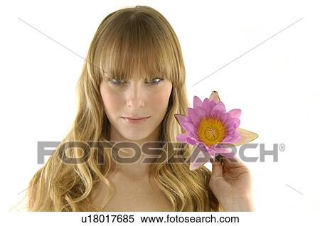 Portrait of a young woman holding a flower View Large Photo Image Stock Photography - Portrait of a young woman holding a flower. Fotosearch