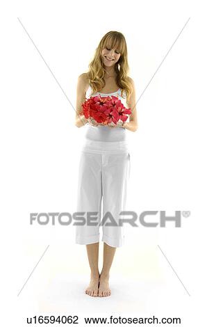Young woman holding a flower pot and smiling View Large Photo Image Stock Image - Young woman holding a flower pot and smiling. Fotosearch