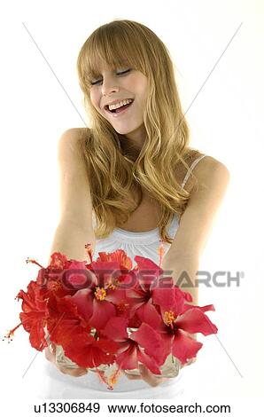 Young woman holding a flower pot and smiling View Large Photo Image Stock Photo - Young woman holding a flower pot and smiling. Fotosearch