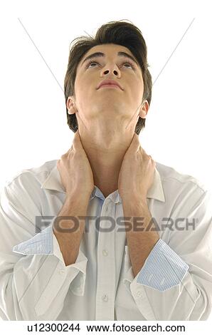 Close-up of a young man with his hands on his neck View Large Photo Image Picture - Close-up of a young man with his hands on his neck. Fotosearch