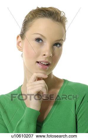 Close-up of a young woman thinking with her hand on her chin View Large Photo Image Stock Photo - Close-up of a young woman thinking with her hand on her chin. Fotosearch