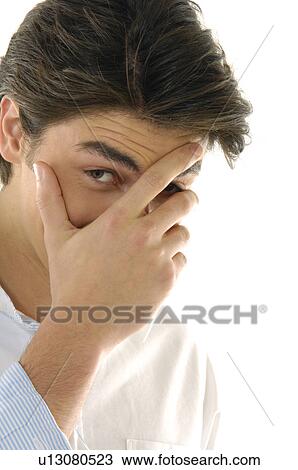 Portrait of a young man covering his face with his hand View Large Photo Image Stock Image - Portrait of a young man covering his face with his hand. Fotosearch