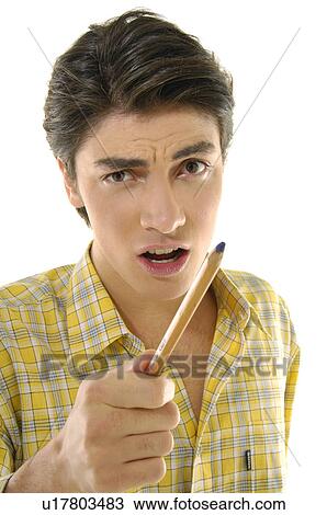 Stock Image - Portrait of a young man holding a pencil. Fotosearch