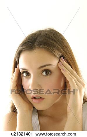 Stock Image - Portrait of a young woman suffering from a headache. Fotosearch