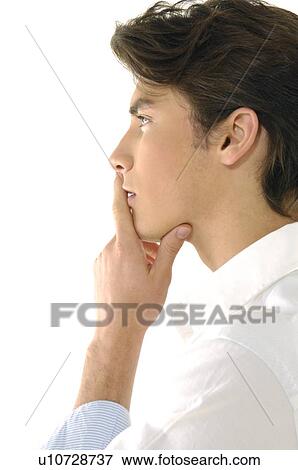 Stock Photo - Side profile of a young man thinking. Fotosearch