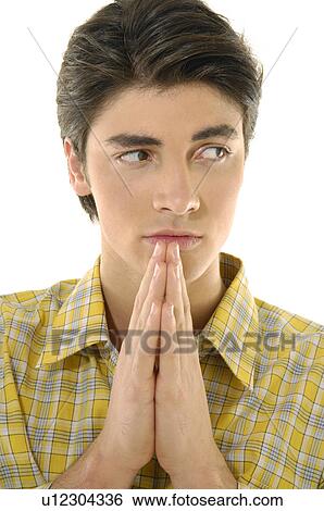 Stock Photograph - Close-up of a young man with his folded hands. Fotosearch