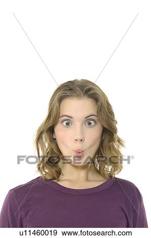 Close-up of a young woman puckering her lips View Large Photo Image Stock Photo - Close-up of a young woman puckering her lips. Fotosearch