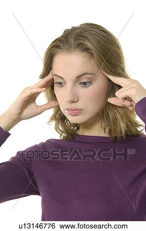 Stock Photograph - Close-up of a young woman suffering from a headache. Fotosearch