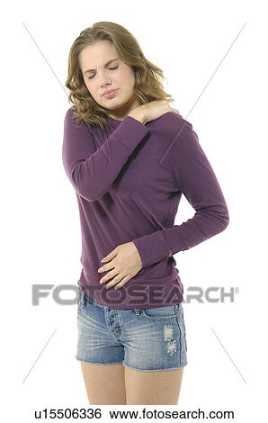 Stock Photograph - Close-up of a young woman suffering from shoulder pain. Fotosearch