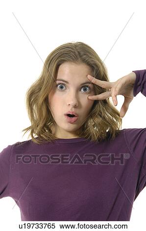 Stock Photography - Portrait of a young woman looking surprised. Fotosearch