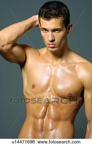 Portrait of a young man flexing his biceps View Large Photo Image Stock Photograph - Portrait of a young man flexing his biceps. Fotosearch