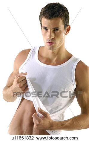 Portrait of a young man holding his vest and posing View Large Photo Image Stock Image - Portrait of a young man holding his vest and posing. Fotosearch
