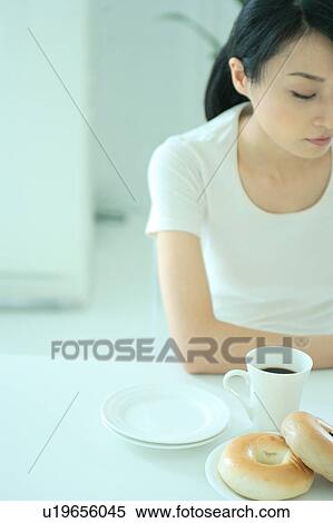 A young woman eating breakfast View Large Photo Image Stock Photography - A young woman eating breakfast. Fotosearch