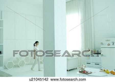 A young woman in living room View Large Photo Image Stock Image - A young woman in living room. Fotosearch