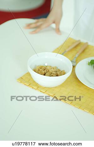 Stock Photo - Cereal and a woman's hand. Fotosearch
