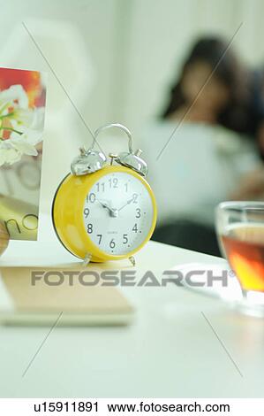 Clock with young women in the background View Large Photo Image Stock Image - Clock with young women in the background. Fotosearch