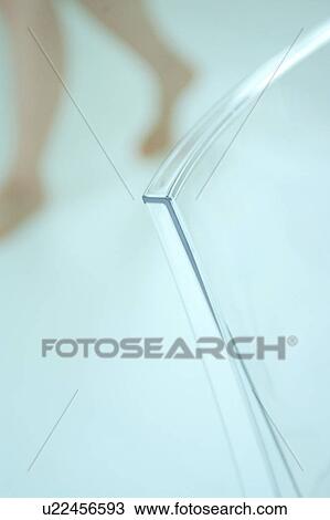 Close-up of a chair with a woman's leg in the background View Large Photo Image Stock Image - Close-up of a chair with a woman's leg in the background. Fotosearch