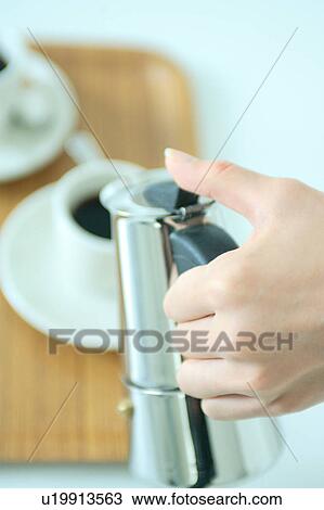 Close-up of a woman pouring coffee View Large Photo Image Stock Image - Close-up of a woman pouring coffee. Fotosearch