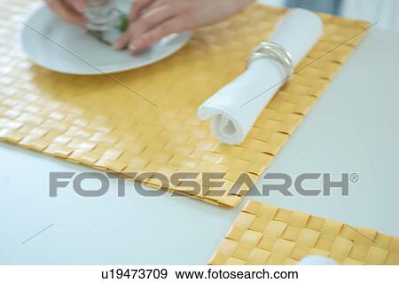 Close-up of a woman setting breakfast View Large Photo Image Stock Photo - Close-up of a woman setting breakfast. Fotosearch