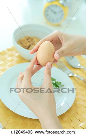 Close-up of a young woman holding boiled egg View Large Photo Image Stock Image - Close-up of a young woman holding boiled egg. Fotosearch
