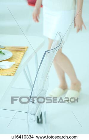 Low section of a young woman in dining room View Large Photo Image Picture - Low section of a young woman in dining room. Fotosearch