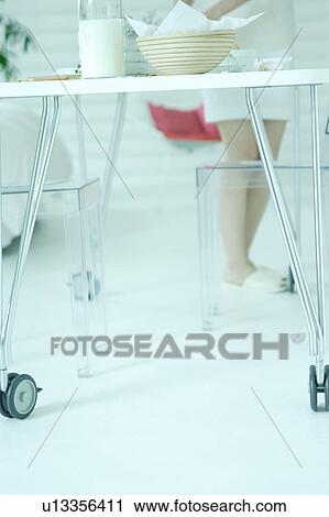 Low section of a young woman in dining room View Large Photo Image Stock Image - Low section of a young woman in dining room. Fotosearch