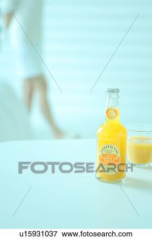 Orange juice with a woman in the background View Large Photo Image Stock Photo - Orange juice with a woman in the background. Fotosearch