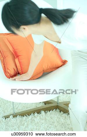 Rear view of a young woman touching chair View Large Photo Image Stock Image - Rear view of a young woman touching chair. Fotosearch