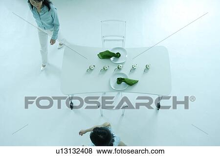 Stock Photo - Two women in dining room. Fotosearch