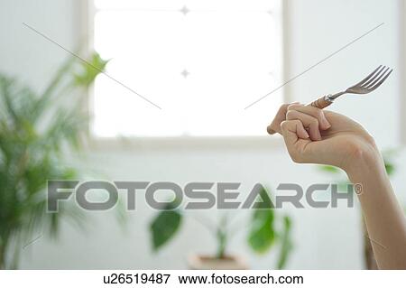 Close-up of a woman's hand with fork View Large Photo Image Stock Photo - Close-up of a woman's hand with fork. Fotosearch