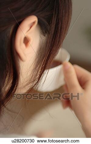 Close-up of a young woman drinking tea View Large Photo Image Stock Image - Close-up of a young woman drinking tea. Fotosearch