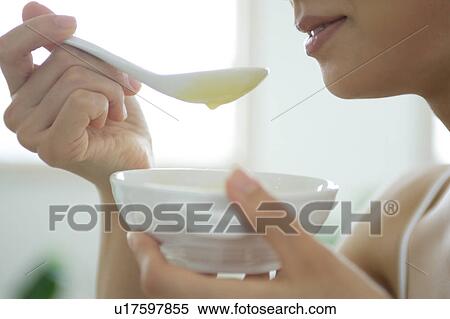 Close-up of a young woman eating soup View Large Photo Image Stock Photography - Close-up of a young woman eating soup. Fotosearch