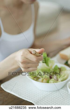 Close-up of a young woman eating breakfast View Large Photo Image Stock Photography - Close-up of a young woman eating breakfast. Fotosearch