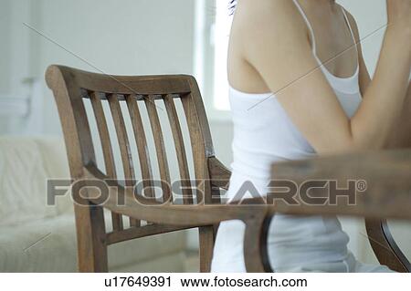 Stock Image - Unrecognizable woman at table for breakfast. Fotosearch