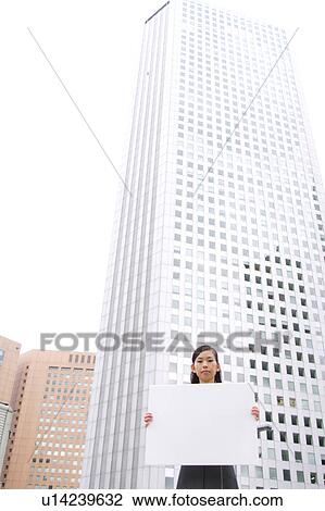 A young business woman holding blank message View Large Photo Image Stock Image - A young business woman holding blank message. Fotosearch