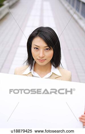 A young business woman holding blank message View Large Photo Image Stock Photography - A young business woman holding blank message. Fotosearch