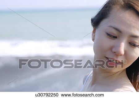 A young woman at beach, close-up View Large Photo Image Stock Image - A young woman at beach, close-up. Fotosearch