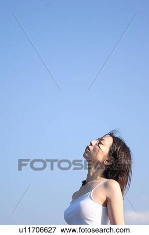 Stock Photo - A young woman at beach. Fotosearch