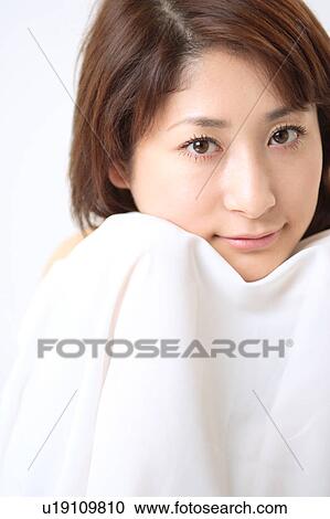 A young woman holding white sheet View Large Photo Image Stock Image - A young woman holding white sheet. Fotosearch