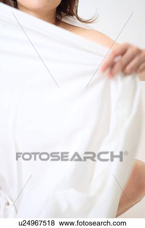 A young woman holding white sheet View Large Photo Image Stock Photo - A young woman holding white sheet. Fotosearch