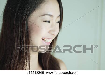 A young woman smiling, close-up View Large Photo Image Stock Photograph - A young woman smiling, close-up. Fotosearch