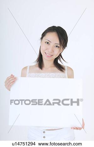 Portrait of a young woman holding blank message View Large Photo Image Picture - Portrait of a young woman holding blank message. Fotosearch