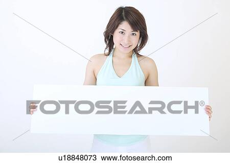 Portrait of a young woman holding blank message View Large Photo Image Stock Image - Portrait of a young woman holding blank message. Fotosearch