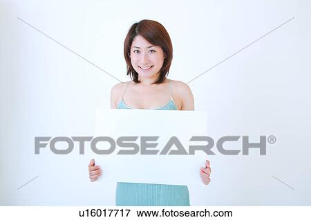 Portrait of a young woman holding blank message View Large Photo Image Stock Photo - Portrait of a young woman holding blank message. Fotosearch