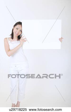 Portrait of a young woman holding blank message View Large Photo Image Stock Photography - Portrait of a young woman holding blank message. Fotosearch
