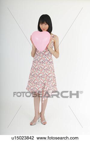 Portrait of a young woman with balloon View Large Photo Image Stock Image - Portrait of a young woman with balloon. Fotosearch