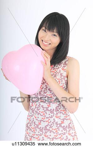 Portrait of a young woman with balloon View Large Photo Image Stock Photography - Portrait of a young woman with balloon. Fotosearch