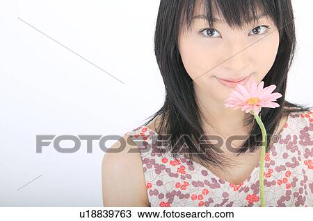 Portrait of a young woman with flower View Large Photo Image Stock Image - Portrait of a young woman with flower. Fotosearch
