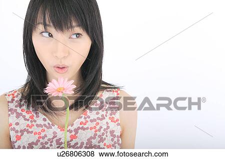 Portrait of a young woman with flower View Large Photo Image Stock Photo - Portrait of a young woman with flower. Fotosearch